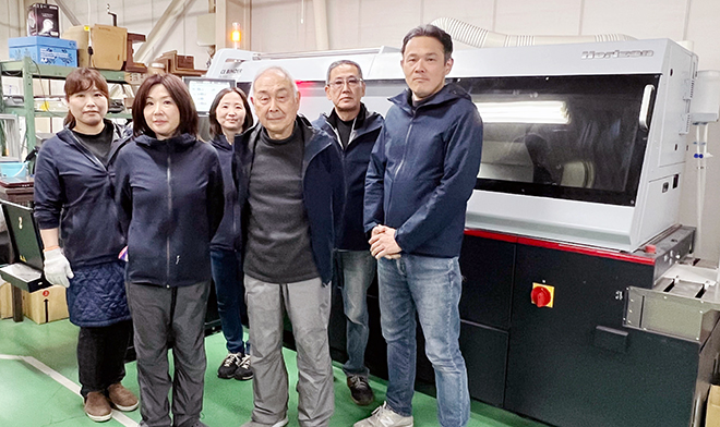 PUR製本機の前で先代社長(中央)、現場スタッフとともに上野社長(右端) PUR製本機の前で先代社長(中央)、現場スタッフとともに上野社長(右端)